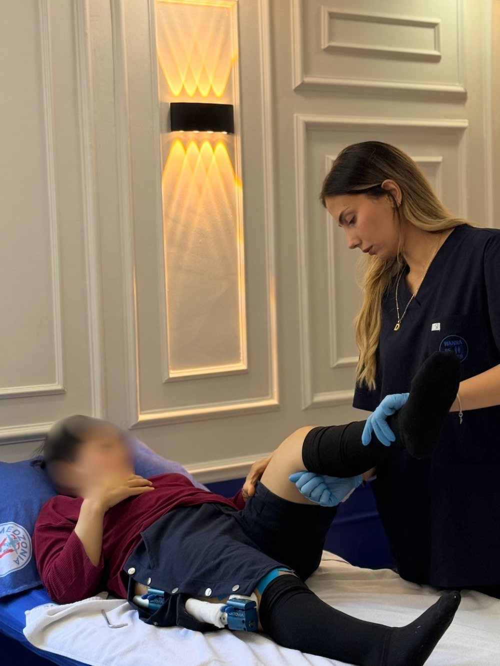 Dilek Can mobilising a patient's knee during the lengthening phase