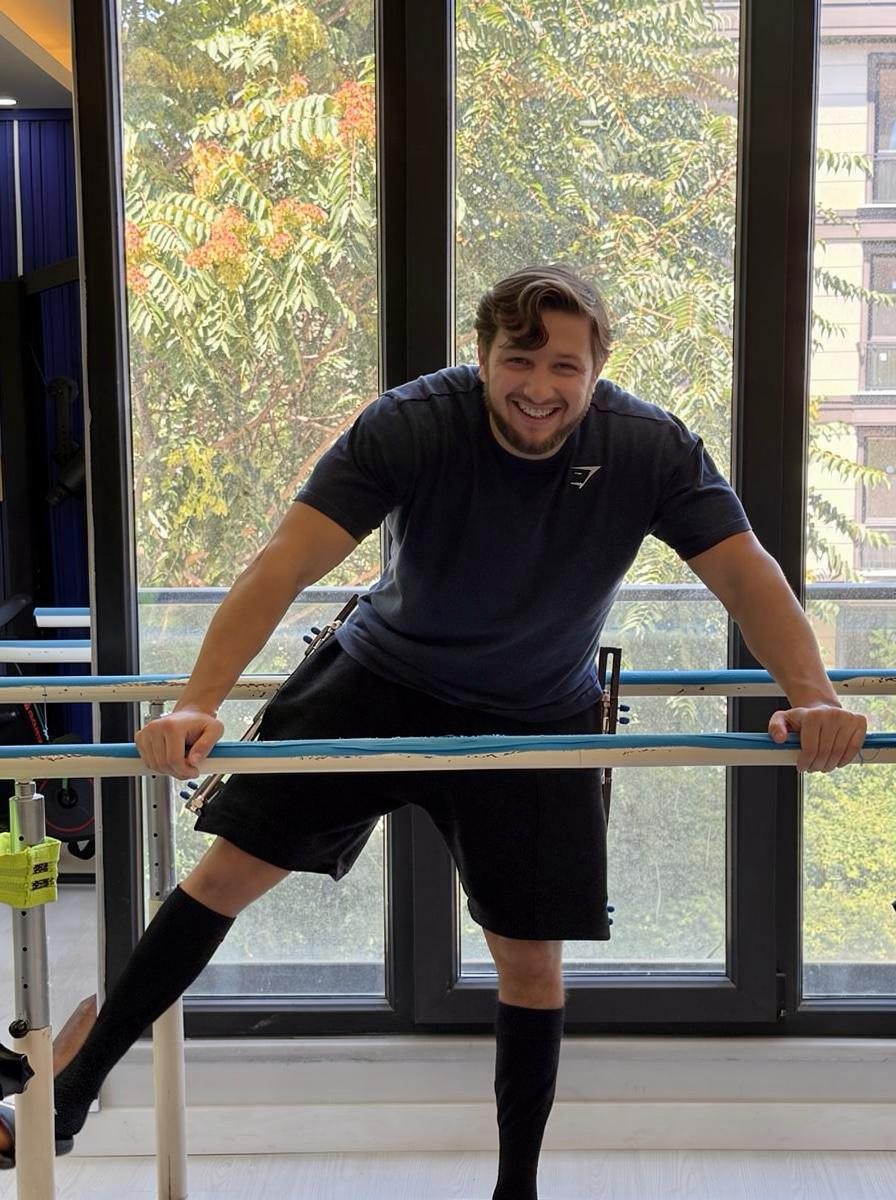 Smiling patient at the parallel bars