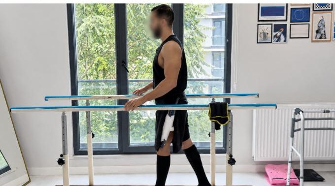 Patient walking between parallel bars